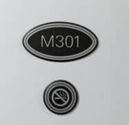 Oval sign reading "M301" above a circular no smoking symbol on a white wall.